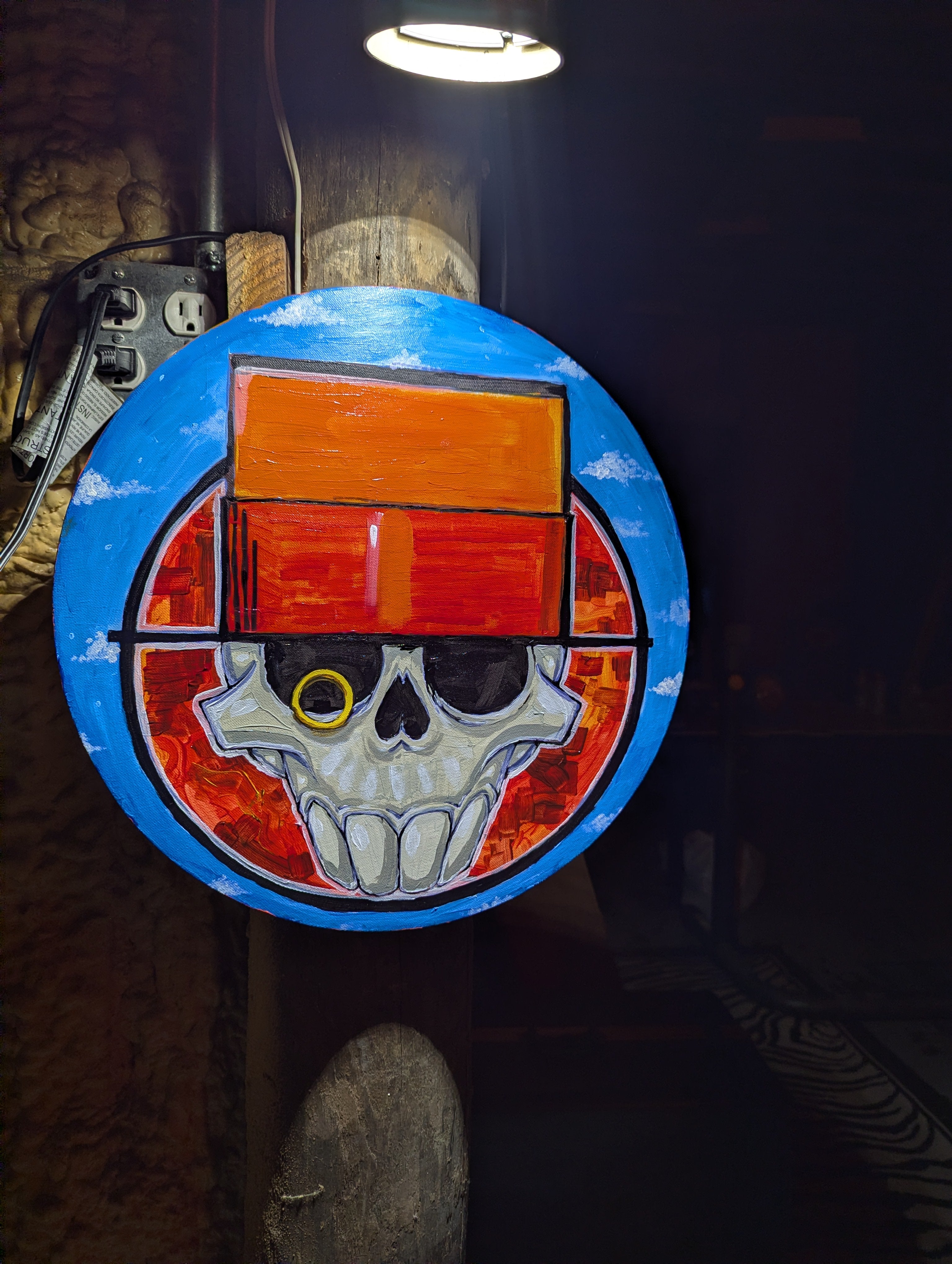 "Skull & Top Hat in the Sky" acrylic on 16" circular canvas. (ORG)